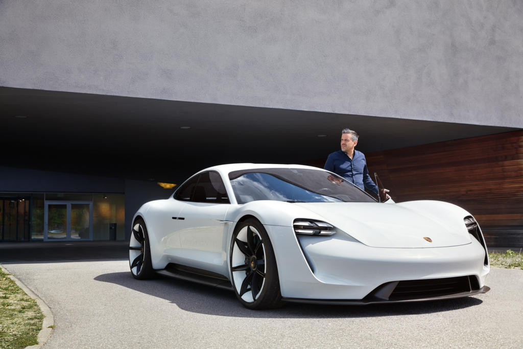 Raphael Gielgen, Zukunftsforscher und Trendscout bei Vitra, mit Porsches Mission-E Prototyp